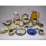 A collection of Torquay Ware including teapots, cups & saucers, jugs, pin dish etc, along with a jug