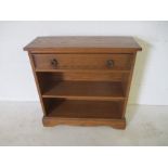 An oak freestanding bookcase with single drawer