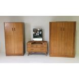 A G-Plan light oak bedroom suite including a dressing table and two wardrobes