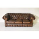 A three seater brown leather Chesterfield sofa