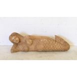 A large wall hanging carved mermaid
