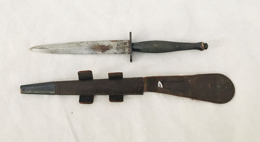 A Fairbairn Sykes fighting knife in leather scabbard, the blade engraved Wilkinson Sword, London