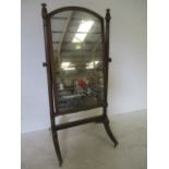 A large Victorian mahogany cheval mirror with turned supports