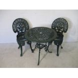 A painted green metal garden bistro set, comprising of a table and two chairs