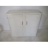 A painted metal two door cupboard