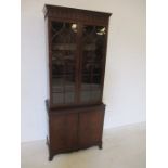 A reproduction display cabinet with cupboard under