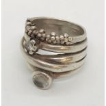 A multi-faceted silver "confusion" ring