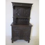 A Victorian carved oak sideboard with panelled back