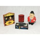 A collection of vintage novelty money boxes including a reproduction metal Punch and Judy Bank