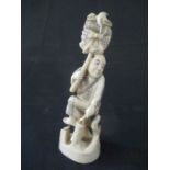 A 19th Century signed Japanese ivory Okimono of a man carrying a bundle, 14cm height