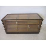 A haberdashery cabinet with twelve drawers - height 69cm, length 143cm, depth 61cm