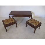 A coffee table, along with a pair of matching combination tables/stools