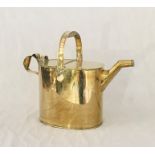 An oversized brass watering can height including handle 40cm.