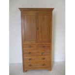 A satin wood linen press with five drawers under - height 213cm, width 101cm, depth 48cm