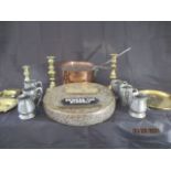 A collection of brass and copper including a saucepan and lid