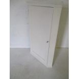 A white painted corner cupboard
