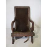 An Anglo Indian heavy carved plantation style chair with dragon decoration. In need of re