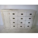 A white painted chest of 12 drawers with cupboard to side - height 106cm, length 161cm, depth 35cm
