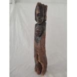 A large African figure group, part carved and part naturalistic, 91cm height