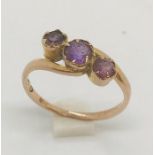 A 9ct rose gold ring with amethysts