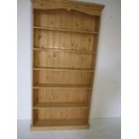 A freestanding pine bookcase - height 190cm, width 98cm, depth 22cm