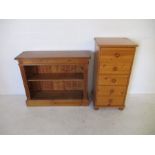 A narrow pine chest of five drawers, along with a book case