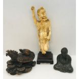 A 19th century carved ivory figure of a mythical horned Oni along with a pewter seated Buddha and