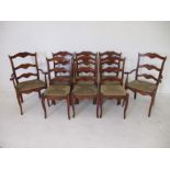 A set of eight rush seated French farmhouse style ladder back chairs including two carvers