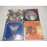 A collection of four metal vinyl records including Black Sabbath "Feels Good To Me", Ozzy Osborne "