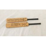 Two miniature cricket bats one bearing the printed signatures of the England 1957 team the other the
