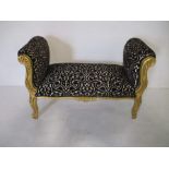 A gilt upholstered window seat.