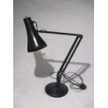 A modern black angle poise lamp