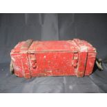 A red painted wooden ammo box with rope handles