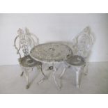 A painted white metal garden bistro set, comprising of a table and two chairs