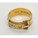 An 18ct gold buckle ring with single diamond flanked by two seed pearls ( 1 missing), weight 4.6g