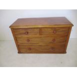 A low mahogany chest of four drawers