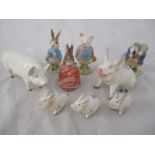 A collection of Beswick figures including Beatrix Potter, Laughing pigs including piglets running