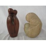 A modernist stone figure group of mother and child along with a wooden figure group, height of