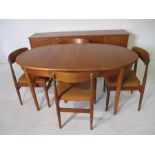 A mid century teak dining suite comprising a table and four chairs plus a sideboard. Sideboard width
