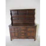 A dark wood Ercol dresser - height 170cm, width 146cm, depth 50cm