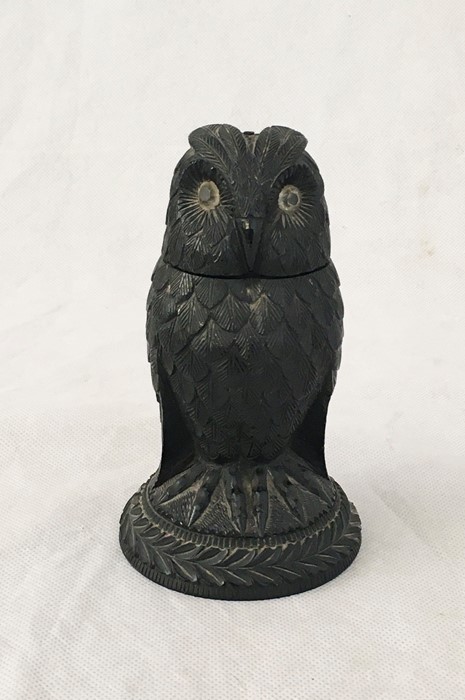 A Black Forest carved owl inkwell with glass eyes and hinged head