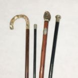 A Royal Marines Artillery swagger stick along with a collection of walking sticks including a silver