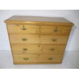 A pine chest of five drawers.