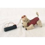 A battery operated Scotty dog with tartan coat. Light up eyes and movable legs and tail