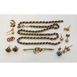 A collection of 9ct gold earrings ( some unmarked) along with scrap 9ct gold and a brooch, total