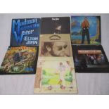 A collection of seven Elton John 12" vinyl records including Goodbye Yellow Brick Road, Captain