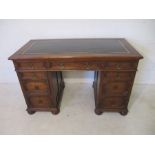 An oak kneehole desk with Jacobean style detailing to drawers