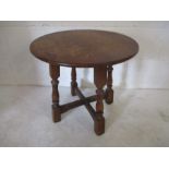 A small circular oak coffee table