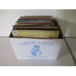 A collection of 12" vinyl records including Elton John, Bob Marley, Dire Straits, Elvis Presley,