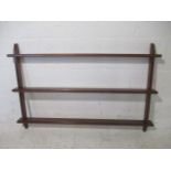 A mid century wall hanging shelf unit.